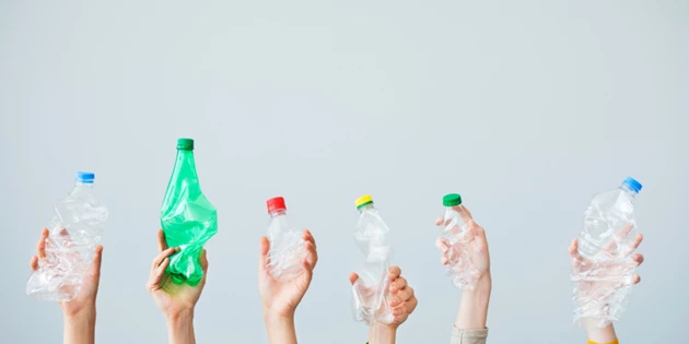 Hands holding plastic bottles