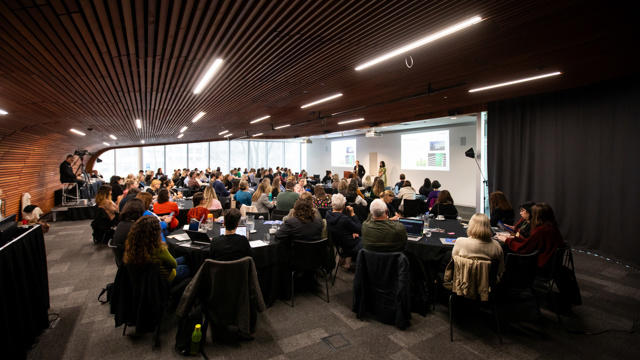 Full room of attendees at course