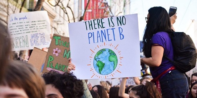People at climate protest with signs