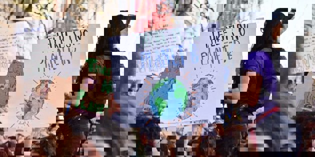 People at climate protest with signs