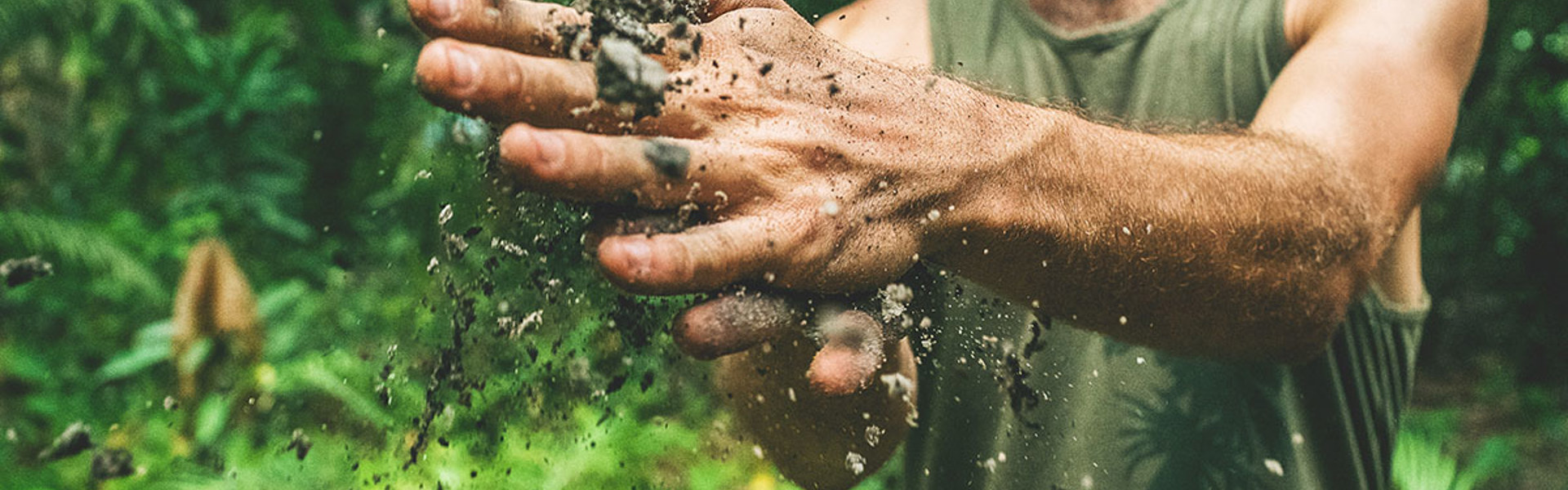 Man brushing dirt out of hands