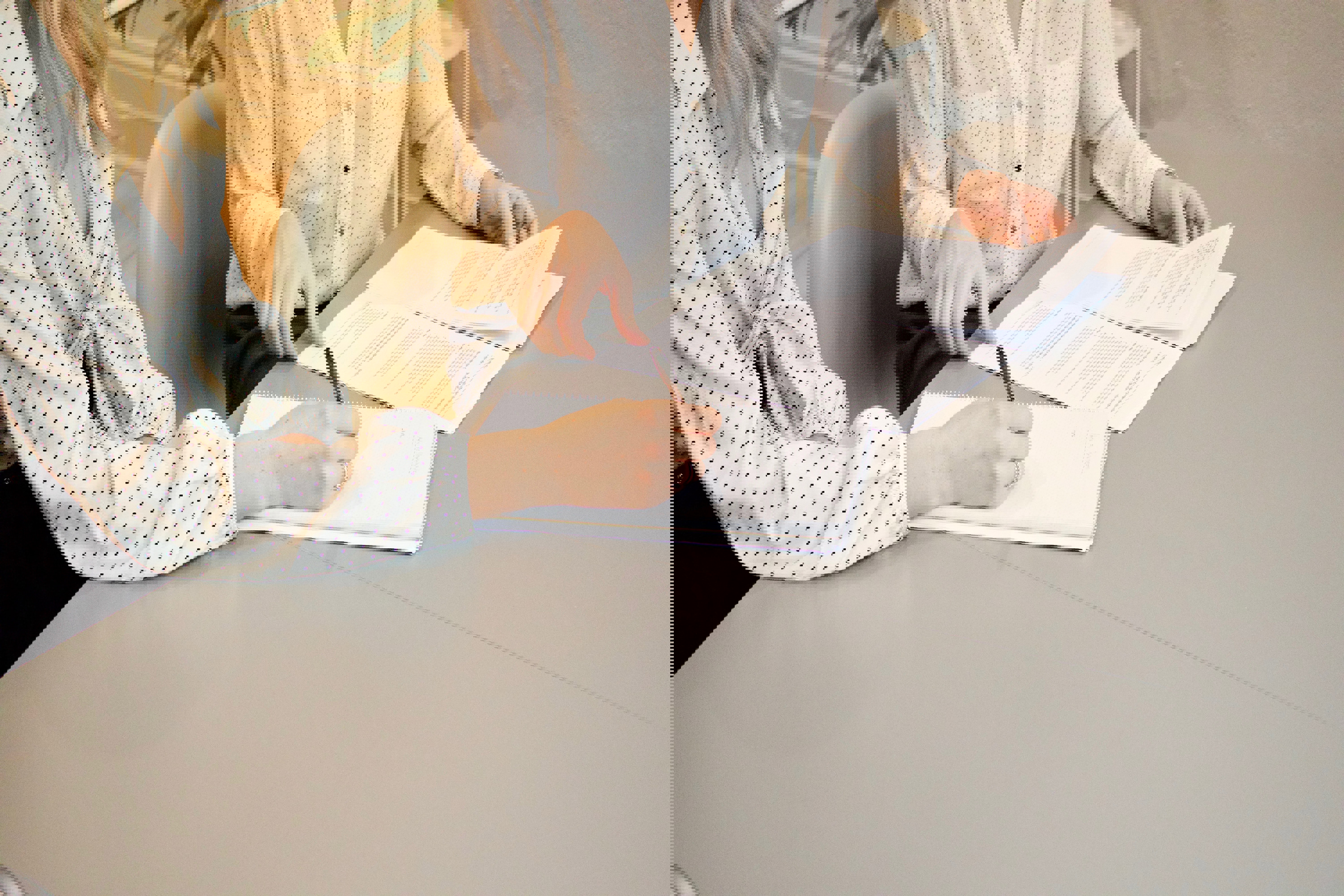 Two woman sign document