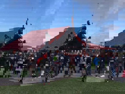 People gathering outside a marae