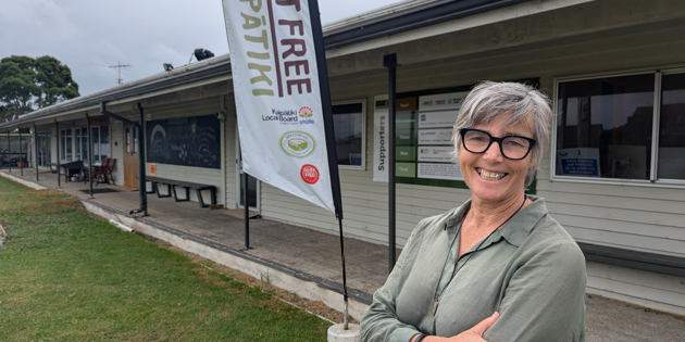 Mary Dignan in front of Pest Free Kaipātiki building