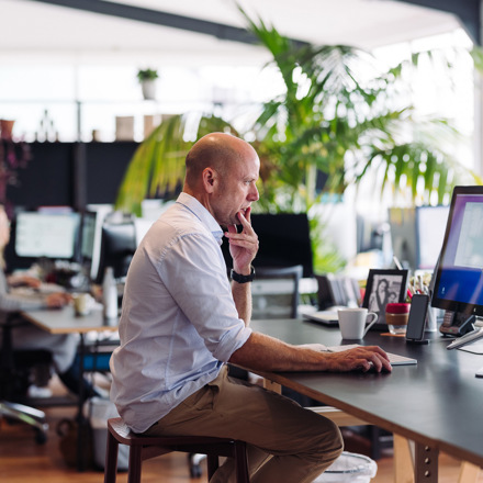 Man working at computer on long desk