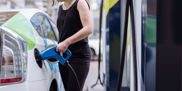 person charging electric car