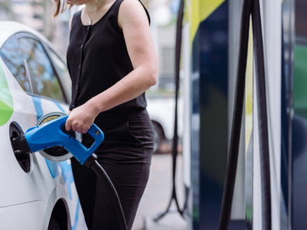 person charging electric car