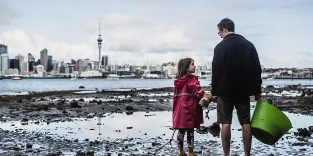 Man and child on foreshore of Hauraki Gulf, Auckland