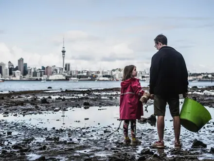 Man and child on foreshore of Hauraki Gulf, Auckland