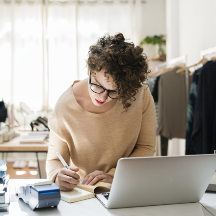 Female Business Owner Is Using Laptop