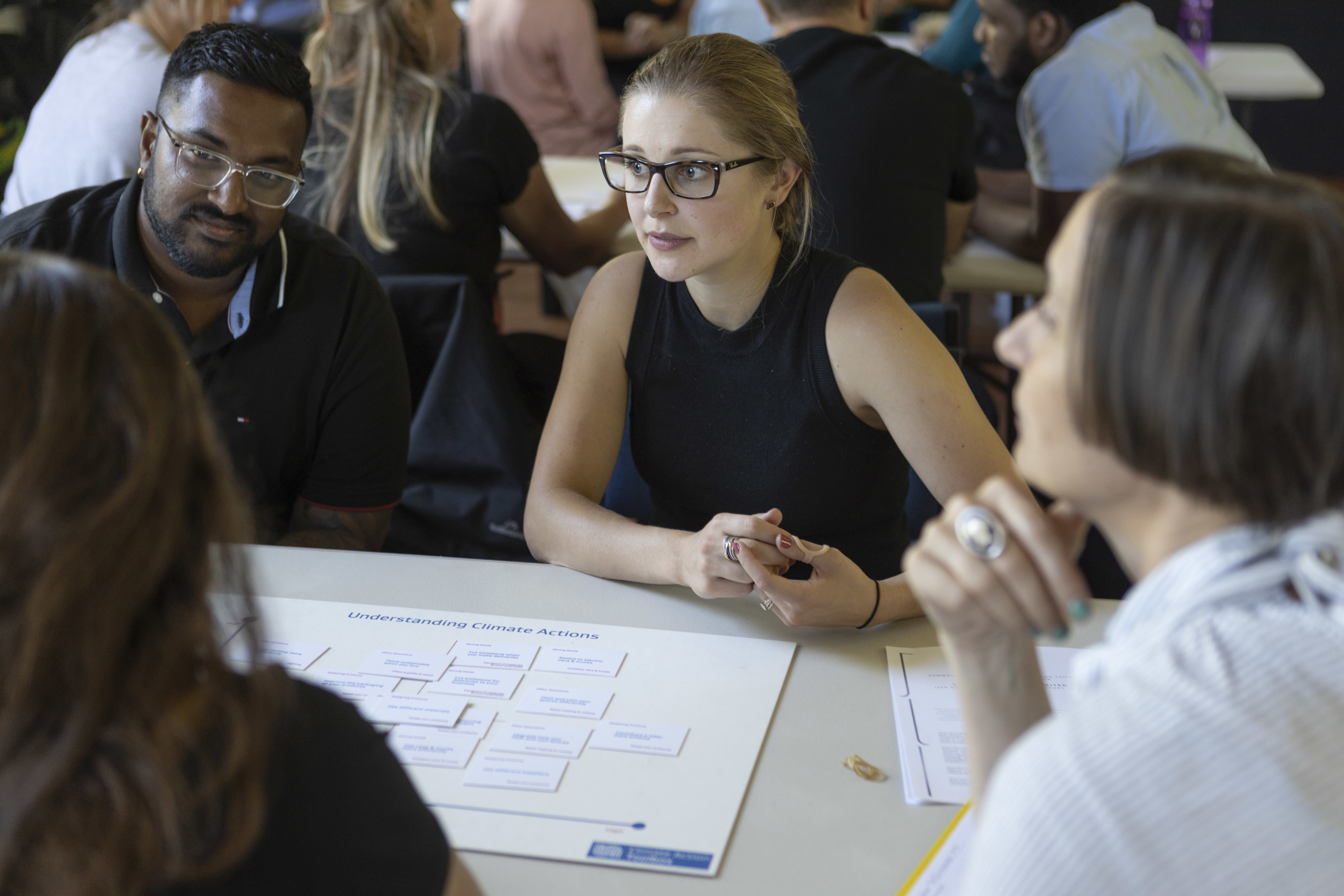 People in discussion around table