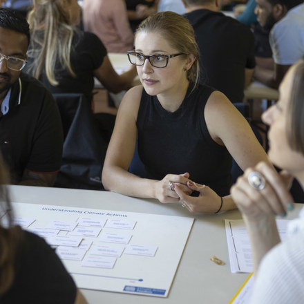 People in discussion around table