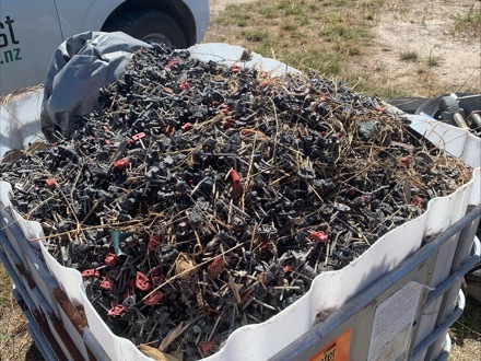Large container of used viticulture clips