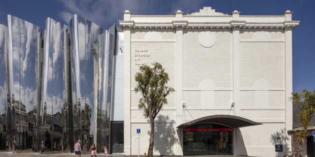 Image of a large art gallery with a cabbage tree in front 
