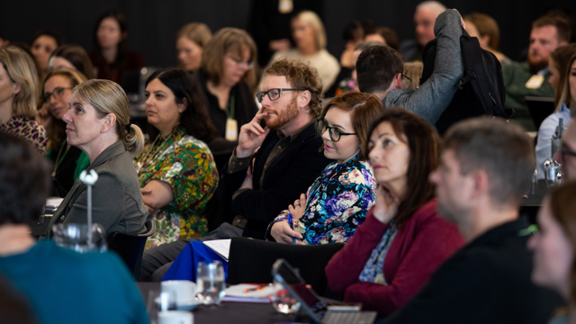 Course attendees listen to presentation