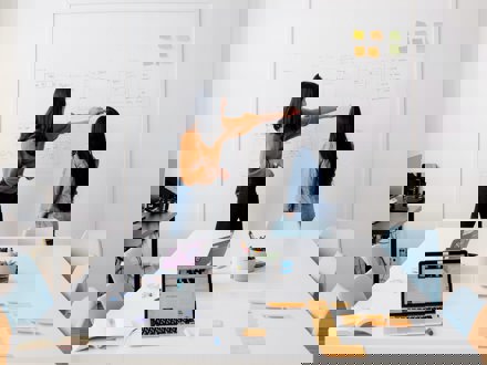 Two women using whiteboard