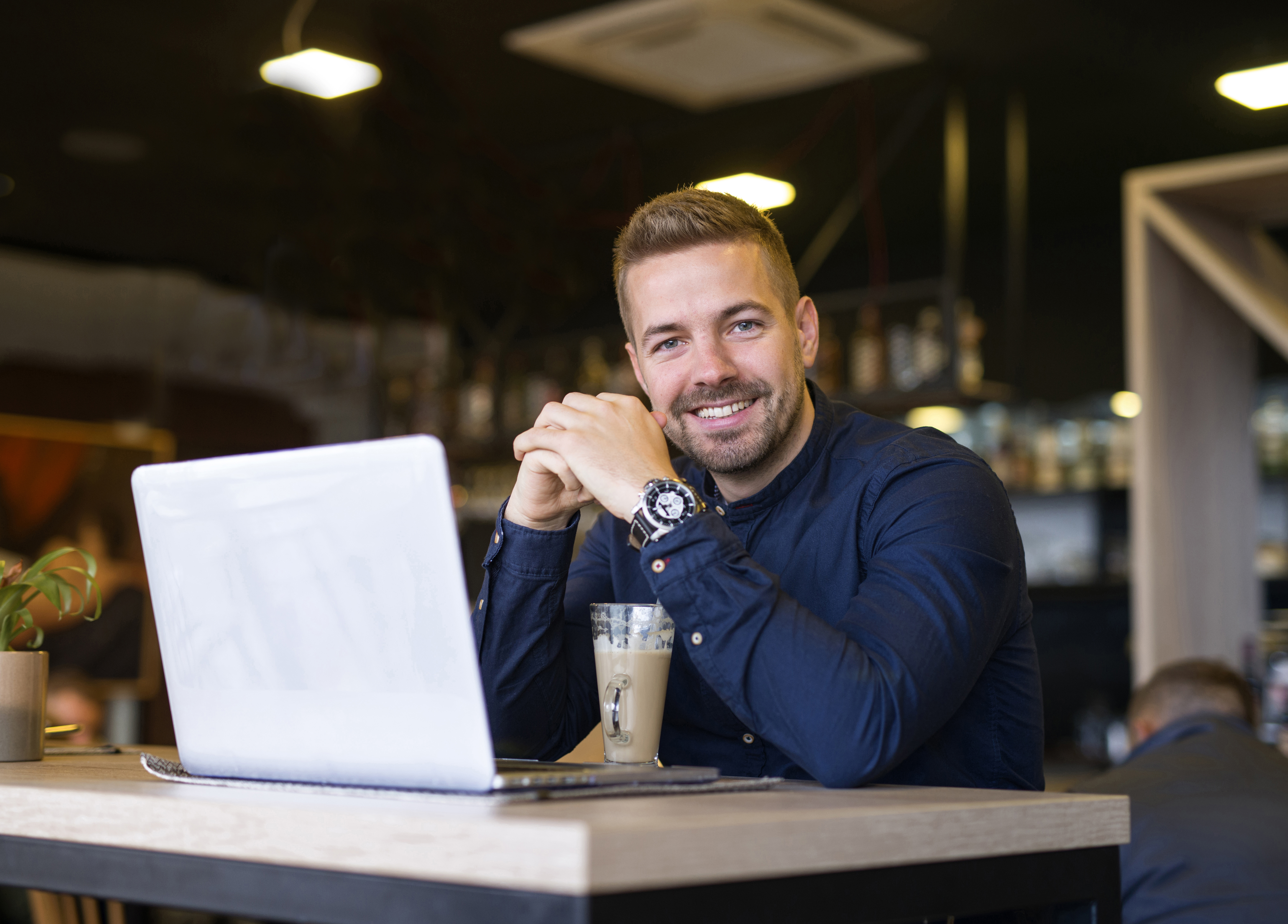 Man in cafe with laptop