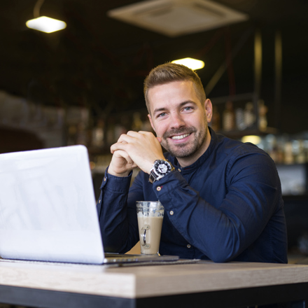 Man in cafe with laptop