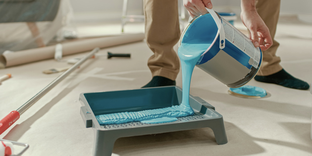 Paint poured from can into tray