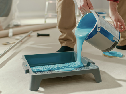 Paint poured from can into tray