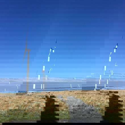 Wind turbines against blue sky