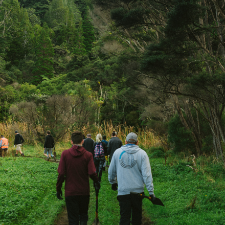 People carrying shovels off to a planting day 