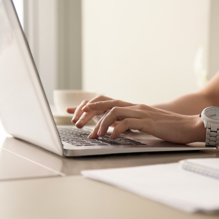 Woman's hands on laptop keyboard