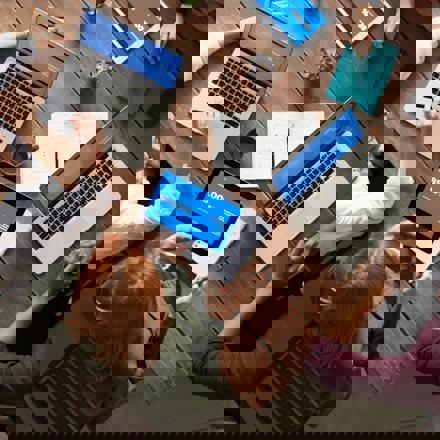 Aerial view of group around table with laptops