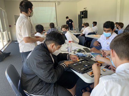 Team dismantling laptop computers