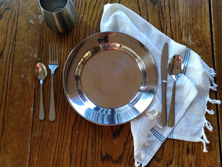 Table setting with plate, utensils and cup