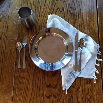 Table setting with plate, utensils and cup
